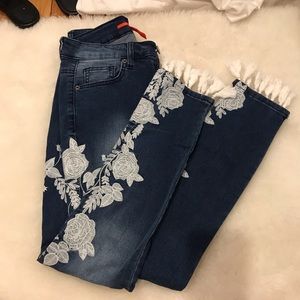Embroidered dark wash jeans with fringe